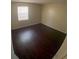 Bright bedroom featuring dark laminate floors and a window at 4335 Aegean Dr # 106A, Tampa, FL 33611