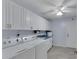 Laundry room with washer, dryer, cabinets, and sink at 2028 Berry Roberts Dr # 52, Sun City Center, FL 33573