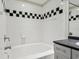 Bathroom with black and white checkered tile and a bathtub at 520 S Armenia Ave # 1232, Tampa, FL 33609