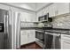 Modern kitchen with stainless steel appliances and dark wood floors at 520 S Armenia Ave # 1232, Tampa, FL 33609