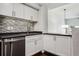 Modern kitchen with white cabinets, mosaic backsplash and stainless steel appliances at 520 S Armenia Ave # 1232, Tampa, FL 33609