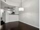 Simple dining room with dark hardwood floors and modern light fixture at 520 S Armenia Ave # 1232, Tampa, FL 33609