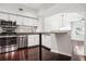 Modern kitchen with dark wood floors, white cabinets, and stainless steel appliances at 520 S Armenia Ave # 1232, Tampa, FL 33609