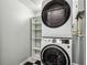 Laundry room with stackable washer and dryer and shelving at 520 S Armenia Ave # 1232, Tampa, FL 33609