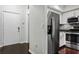 Clean entryway with dark hardwood floors and modern kitchen view at 520 S Armenia Ave # 1232, Tampa, FL 33609