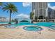 Beautiful pool with waterfall feature, bridge, hot tub, and lush tropical landscaping around the pool area at 1209 E Cumberland Ave # 807, Tampa, FL 33602