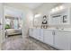 Bright bathroom features stylish tile floors, double vanity, and view to Primary bedroom at 13939 Swallow Hill Dr, Lithia, FL 33547