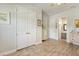 Hallway featuring light wood floors, closet, and doorway to bathroom at 13939 Swallow Hill Dr, Lithia, FL 33547