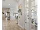 Hallway view of office with French doors, leading to living and dining spaces at 13939 Swallow Hill Dr, Lithia, FL 33547