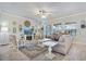 Cozy living room with large windows and a ceiling fan at 13939 Swallow Hill Dr, Lithia, FL 33547