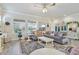 Bright living room with large windows, ceiling fan and comfortable seating at 13939 Swallow Hill Dr, Lithia, FL 33547
