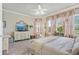 Comfortable main bedroom with soft furnishings, large windows and stylish decor at 13939 Swallow Hill Dr, Lithia, FL 33547