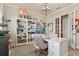 Inviting home office with built-in shelving and a view to the hallway through French doors at 13939 Swallow Hill Dr, Lithia, FL 33547
