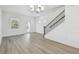 Bright living room features wood floors, a modern chandelier, and a staircase with wood and black iron accents at 1734 W Cherry St, Tampa, FL 33607