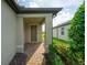 Inviting entryway with a covered porch and brick walkway at 18784 Coastal Shore Ter, Land O Lakes, FL 34638