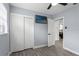 Bright bedroom with tile floors, a double door closet, and a view into the kitchen at 626 E Davis Blvd, Tampa, FL 33606