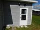 Grey exterior shed with white door and small window at 37303 8Th Ave, Zephyrhills, FL 33542