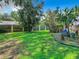 Landscaped backyard with lush lawn and wooden fence at 3015 Forest Club Dr, Plant City, FL 33566