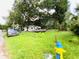 House with a large grassy yard and mature trees at 5907 8Th S Ave, Tampa, FL 33619