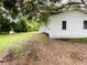 Simple one-story house with a large backyard and mature trees at 5907 8Th S Ave, Tampa, FL 33619