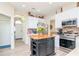 Kitchen with island, stainless steel appliances and light wood floors at 11038 Ancient Futures Dr, Tampa, FL 33647