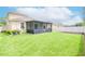Large backyard with a screened patio and lush lawn at 11038 Ancient Futures Dr, Tampa, FL 33647