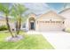 House exterior with two-car garage and palm trees at 11038 Ancient Futures Dr, Tampa, FL 33647