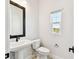 Powder room with a pedestal sink and window with community views at 7404 Newham Ln, Sarasota, FL 34240