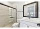 Modern bathroom featuring a tiled shower with a glass door and sleek fixtures at 7404 Newham Ln, Sarasota, FL 34240