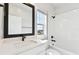 Modern bathroom with white subway tile, quartz countertop, and black hardware at 7404 Newham Ln, Sarasota, FL 34240