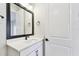 Stylish bathroom featuring modern vanity, lighting, and a dark framed mirror at 7404 Newham Ln, Sarasota, FL 34240