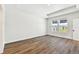 Bright bedroom with hardwood floors, recessed lighting, and windows offering a view of the outside at 7404 Newham Ln, Sarasota, FL 34240