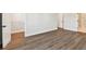 Bedroom with wood floors and white trim, complemented by natural light and ample closet space at 7404 Newham Ln, Sarasota, FL 34240