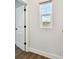 Hallway featuring a window view and doorway at 7404 Newham Ln, Sarasota, FL 34240