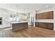 Bright kitchen featuring a central island, white cabinetry, stainless steel appliances, and tile backsplash at 7404 Newham Ln, Sarasota, FL 34240