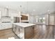Open concept, new kitchen with stainless steel appliances, white cabinets, and hardwood floors at 7404 Newham Ln, Sarasota, FL 34240
