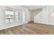 Living area featuring wood flooring, natural light from windows, and access to a balcony and staircase at 7404 Newham Ln, Sarasota, FL 34240