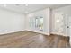 Bright living room with wood floors, recessed lighting, and sliding doors leading to an outdoor balcony at 7404 Newham Ln, Sarasota, FL 34240