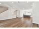 Spacious living area leading to a modern kitchen with an island, stainless steel appliances, and white cabinets at 7404 Newham Ln, Sarasota, FL 34240