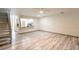 Spacious living area with wood-look floors and a staircase at 14028 Notreville Way, Tampa, FL 33624