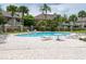 Community pool with lounge chairs and patio area at 14028 Notreville Way, Tampa, FL 33624