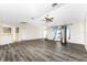 Living room with wood-look floors, vaulted ceilings and view of kitchen at 684 Corrientes Cir, Punta Gorda, FL 33983