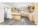 Kitchen with an island, light wood cabinets, and vinyl flooring at 684 Corrientes Cir, Punta Gorda, FL 33983