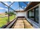 Relaxing screened porch with wicker furniture, perfect for enjoying the outdoors at 684 Corrientes Cir, Punta Gorda, FL 33983