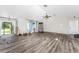 Spacious living room featuring wood-look floors and vaulted ceilings at 684 Corrientes Cir, Punta Gorda, FL 33983