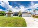 House exterior with solar panels, driveway, and well-maintained lawn at 684 Corrientes Cir, Punta Gorda, FL 33983