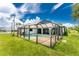 Inviting backyard oasis with a screened-in pool and spacious grassy area at 684 Corrientes Cir, Punta Gorda, FL 33983