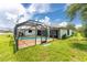 Home features a refreshing pool with a screened enclosure in the backyard at 684 Corrientes Cir, Punta Gorda, FL 33983