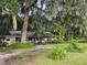 Ranch home with covered porch and lush landscaping on large lot at 15222 Lost Lake Ln, Lithia, FL 33547