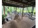 Relaxing screened porch with wooden floors and seating at 15222 Lost Lake Ln, Lithia, FL 33547